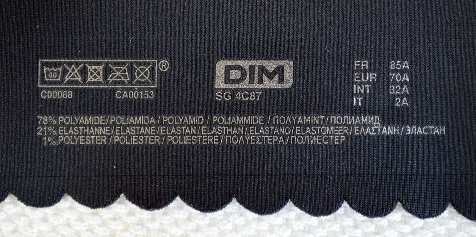Bra care label showing the same bra sized four ways: 85A in France, 70A in Europe, 32A internationally, and 2A in Italy